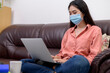 © PK Studio - woman in face mask with laptop during Learning at home