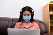 © PK Studio - woman in face mask with laptop during Learning at home