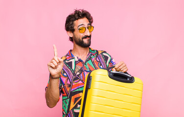 Poster - young bearded man smiling and looking friendly, showing number one or first with hand forward, counting down