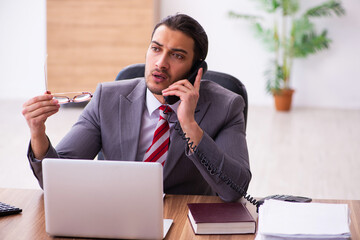 Young male employee working in the office