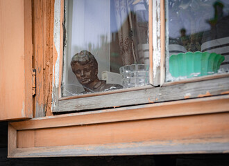 bust of poet Yesenin inside the window on the windowsill