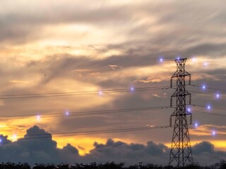 Silhouette High voltage electric tower on sunset time and sky on sunset time background.