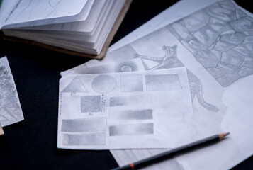 Sheets with pencil drawings with concept in close up.