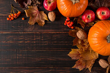 Orange Pumpkins, Fallen Leaves, Apples, Nuts, Berries On Wooden Background. Concept Autumn Template, Blank Halloween Or Thanksgiving Day. Copy Space.