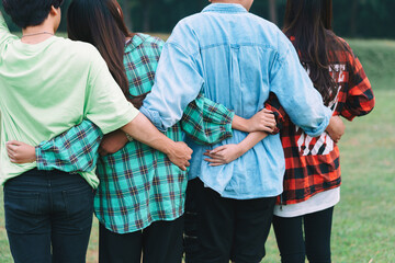 Group of Asian people huddle together