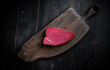© Adsloboda - Cold Smoked Tuna Fillet . Seafood on a wooden chopping board. Top view.