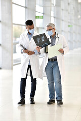 Wall Mural - Doctor with medical intern analysing XR results