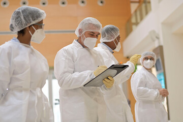 Wall Mural - Medical team standing in hospital, getting feedback