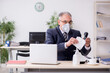 © Elnur - Old male boss employee working during pandemic