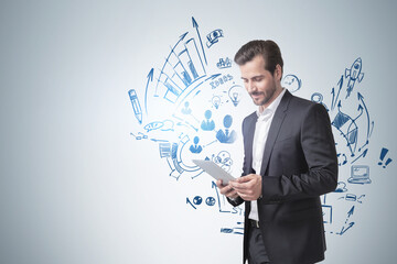 Wall Mural - Man with tablet computer and his business plan