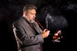 © idea_studio - Solid confident bearded man in suit with glass of whisky smoking pipe