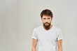 © SHOTPRIME STUDIO - man in white t-shirt gesturing with his hands studio dissatisfaction lifestyle light background
