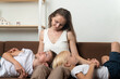 © somemeans - Young mother and two obedient sons put their heads on her knees. Trusting relationship