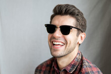Portrait Of A Happy Young Man In Black Sunglasses And Beautiful Big Smile Looking In To The Camera 
