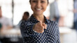 © fizkes - We want you in our team. Close up of smiling mixed race lady hr employer standing at office workspace in middle of day pointing finger at camera choosing you spectator to join staff posing challenge