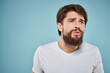 © SHOTPRIME STUDIO - Bearded man emotions white t-shirt lifestyle gestures with hands blue backgrounds