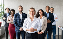 Successful Businesswoman Standing In Front Of Business Team In Office