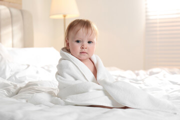 Sticker - Cute little baby with soft towel on bed after bath