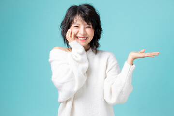 Portrait of pretty woman posing gesture with hands image isolated on aqua blue studio background