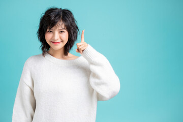 Portrait of pretty woman posing gesture with hands image isolated on aqua blue studio background