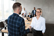 © Prostock-studio - Businessman Shaking Hands With Businesswoman During Corporate Meeting In Office