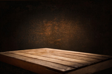 image of a wooden table on an abstract dark background with light in the center