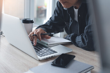 Man online working on laptop computer from home or student studying online class