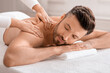 © Prostock-studio - Closeup of relaxed man having body massage at spa