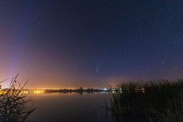 Wall Mural - a magical starry night on the river by the milky way and a comet in the sky