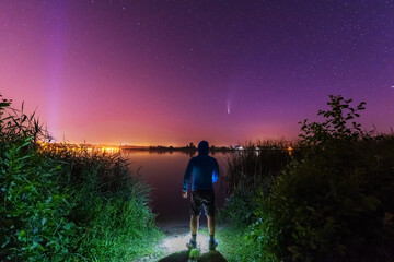 Wall Mural - A magical starry night on the river by the Milky Way and a comet in the sky