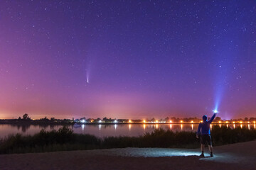 Wall Mural - A magical starry night on the river by the Milky Way and a comet in the sky