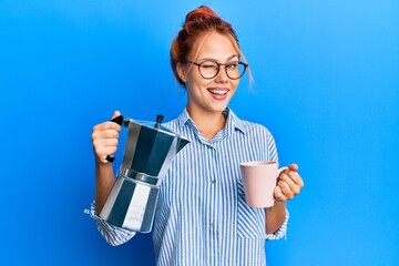 Poster - Young redhead woman drinking italian coffee winking looking at the camera with sexy expression, cheerful and happy face.