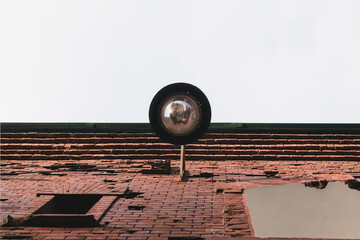 Modern lantern on the wall of an old building