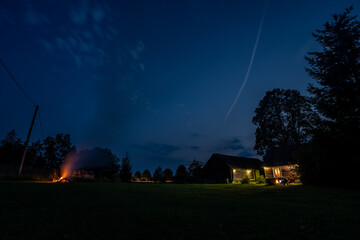 Wall Mural - overhead milky way with stars in clear summer night. old barn house. country side.