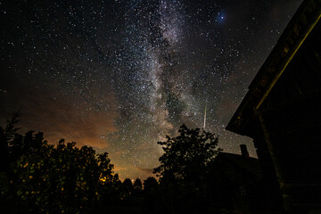 Wall Mural - overhead milky way with stars in clear summer night. old barn house. country side.