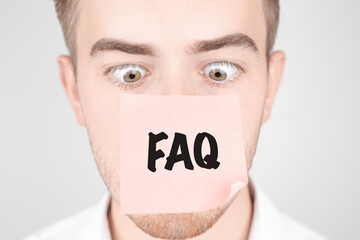 Poster - Man with a red sticker on his nose reads the text FAQ