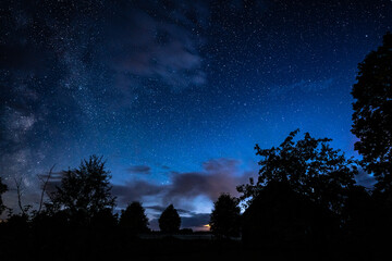 Wall Mural - overhead milky way with stars in clear summer night. old barn house. country side.
