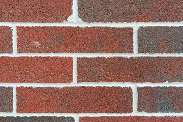 Wall Mural - a closeup view of a red and brown brick wall with white grout displaying detail weathered horizontal retro surface pattern construction and colorful rustic rough textured natural aged surface