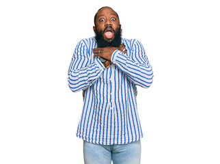 Young african american man wearing business shirt shouting and suffocate because painful strangle. health problem. asphyxiate and suicide concept.