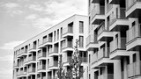 Fototapeta Uliczki - Detail of modern residential flat apartment building exterior. Fragment of new luxury house and home complex. Black and white.
