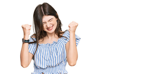 Wall Mural - Young beautiful caucasian girl wearing casual clothes excited for success with arms raised and eyes closed celebrating victory smiling. winner concept.