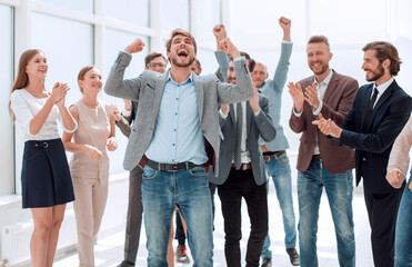 Wall Mural - happy young businessman standing in front of his business team.