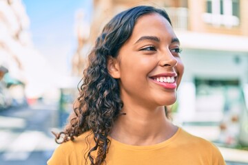 Young african american girl smiling happy walking at city.