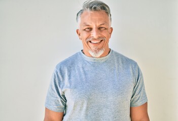 Sticker - Middle age hispanic grey-haired man smiling happy standing at the city.