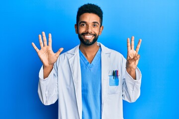 Wall Mural - Handsome young hispanic business man wearing doctor uniform afraid and terrified with fear expression stop gesture with hands, shouting in shock. panic concept.