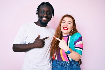 Sticker - Interracial couple wearing casual clothes cheerful with a smile on face pointing with hand and finger up to the side with happy and natural expression