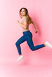 © Asier - Young caucasian blonde woman jumping on pink background
