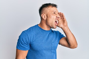 Sticker - Handsome muscle man wearing casual clothes shouting and screaming loud to side with hand on mouth. communication concept.