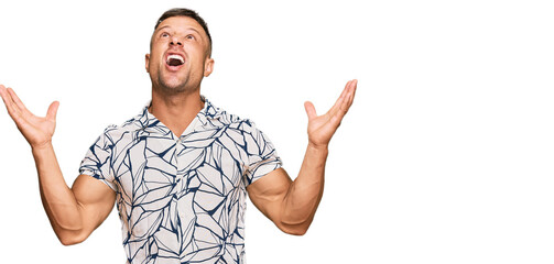 Wall Mural - Handsome muscle man wearing casual clothes crazy and mad shouting and yelling with aggressive expression and arms raised. frustration concept.