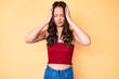 © Krakenimages.com - Young beautiful chinese girl wearing summer clothes suffering from headache desperate and stressed because pain and migraine. hands on head.